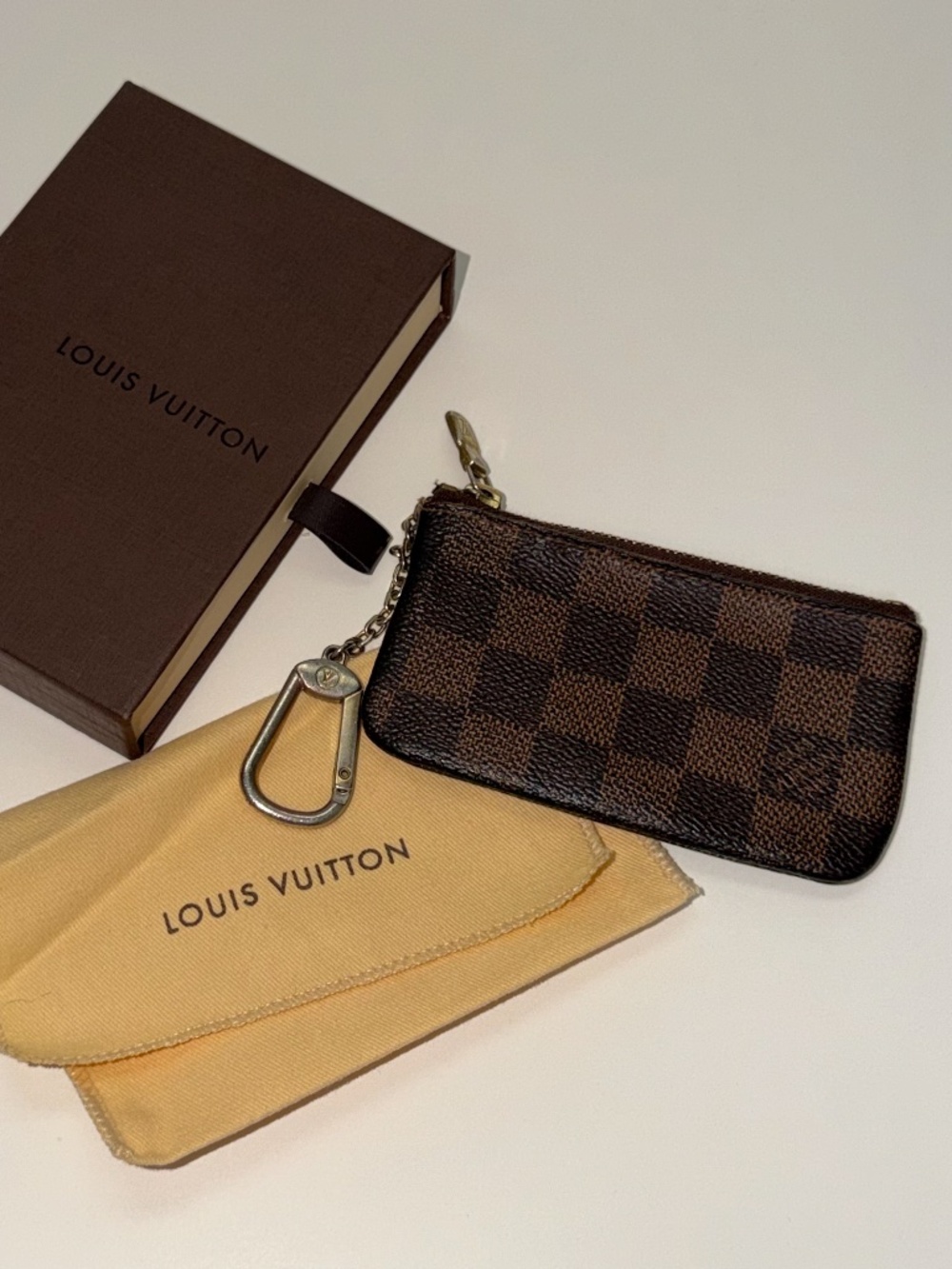 Louis Vuitton Key Pouch in the iconic brown Damier Ebene checkered canvas